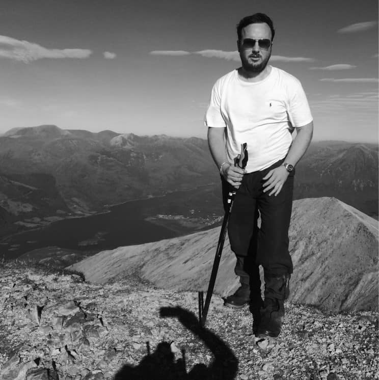 Medium close up photo of standing on top a munro