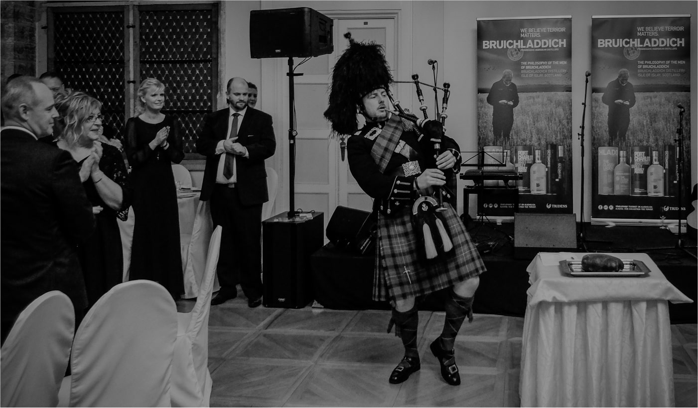 Piper, Philip barlow, playing the bagpipes at a Bruichladdich Burns Night event